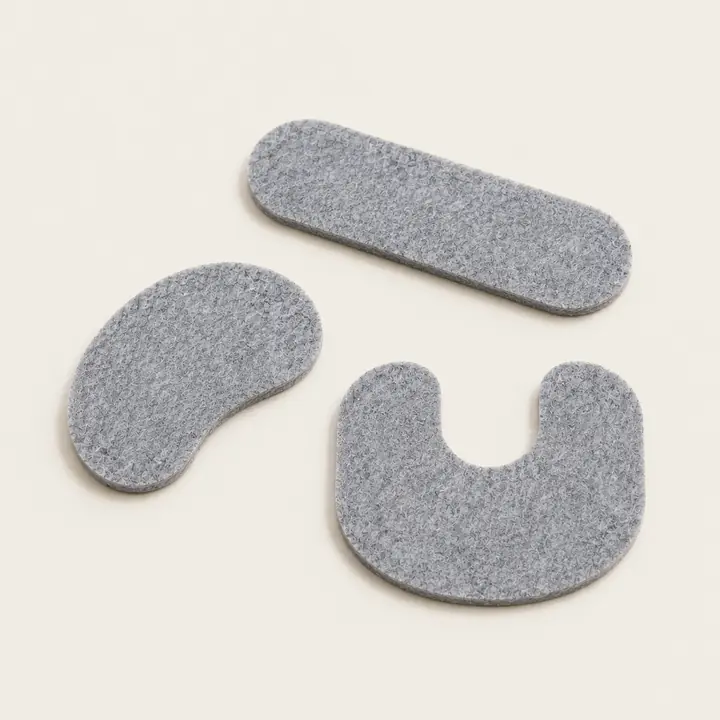 Custom die-cut gray Feltease felt pads in capsule, kidney and U shapes