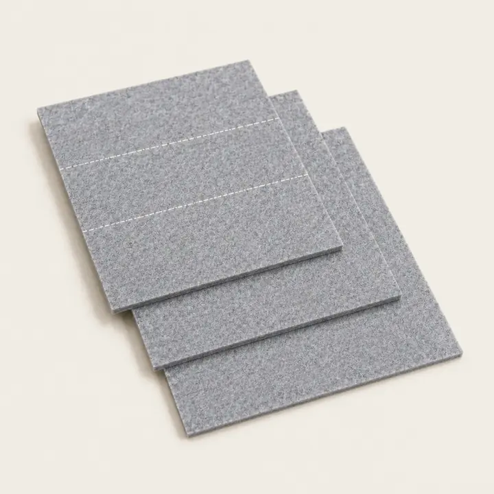 Stacked gray Feltease cut-to-size felt sheets with cutting guides